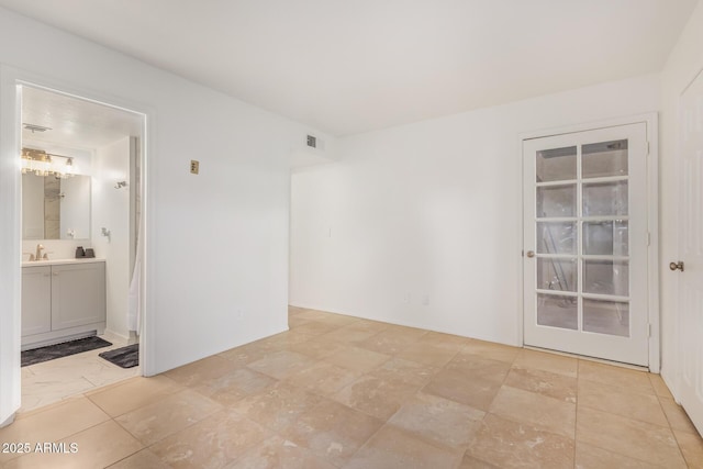 spare room with visible vents and a sink