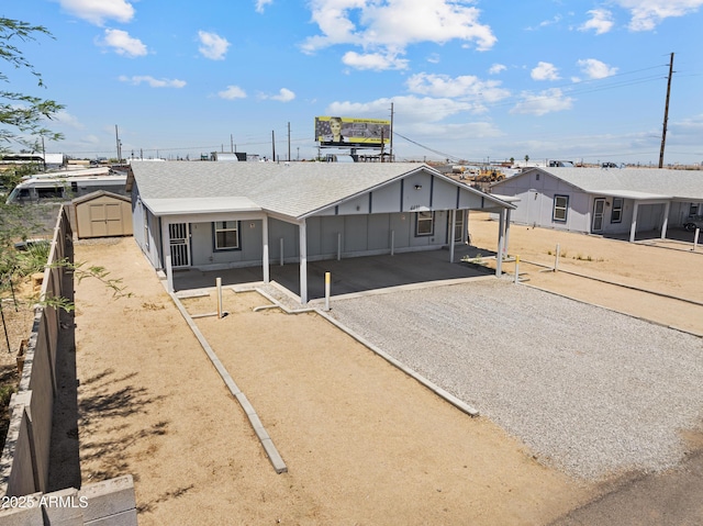 4410 S 12th Dr Unit 1-2, Phoenix, AZ 85041 - view of front of home with driveway, an attached carport, board and batten siding, and roof with shingles