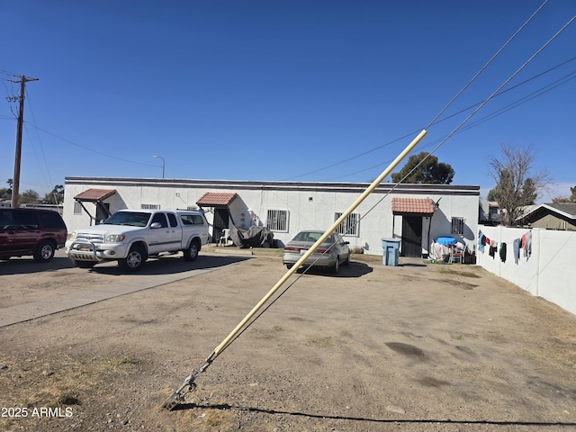 exterior space with uncovered parking and fence