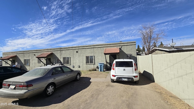 exterior space with fence and stucco siding