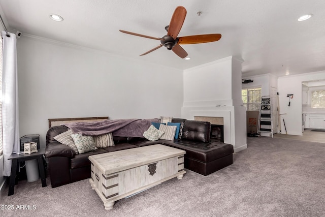 10101 N Arabian Trl Unit 2018, Scottsdale, AZ 85258 - living area with crown molding, ceiling fan, recessed lighting, light colored carpet, and a fireplace