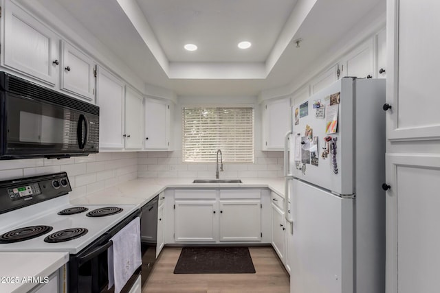 10101 N Arabian Trl Unit 2018, Scottsdale, AZ 85258 - kitchen with black appliances, a sink, white cabinetry, light wood-style flooring, and recessed lighting