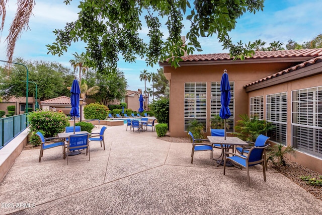 10101 N Arabian Trl Unit 2018, Scottsdale, AZ 85258 - view of patio / terrace with outdoor dining area, a community pool, and fence