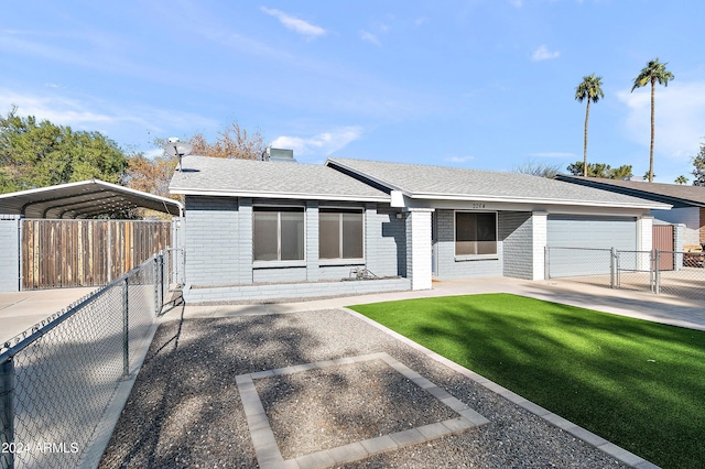 view of front of property with a carport, a garage, and a front lawn