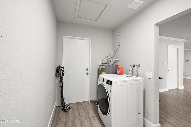 laundry room with water heater, washer / clothes dryer, and light hardwood / wood-style flooring