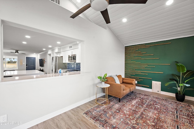 living area with hardwood / wood-style floors, wooden ceiling, ceiling fan, and lofted ceiling