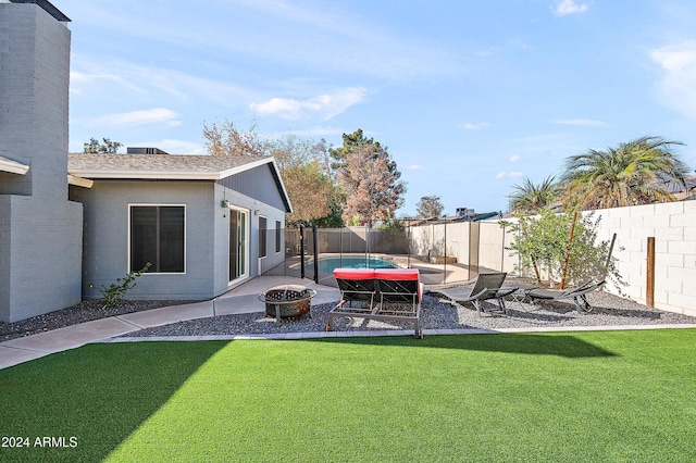 view of yard featuring an outdoor fire pit and a patio