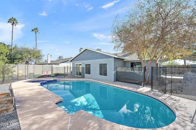 view of pool featuring a patio and a hot tub