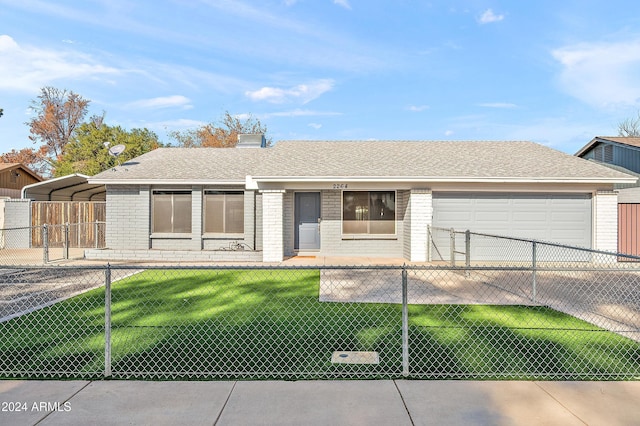 ranch-style home featuring a front yard, a garage, and a carport