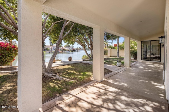 view of patio with a water view