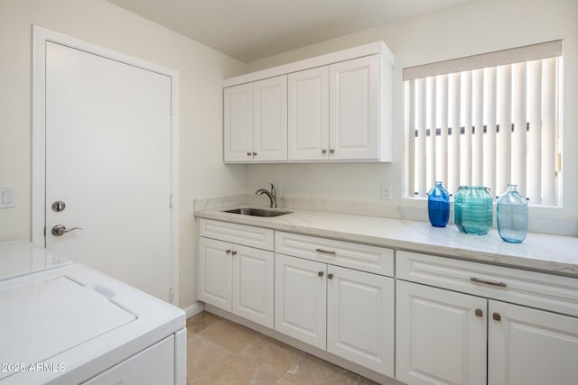 laundry room featuring a sink, cabinet space, and washer and dryer