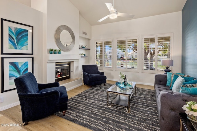 living area featuring visible vents, plenty of natural light, and wood finished floors