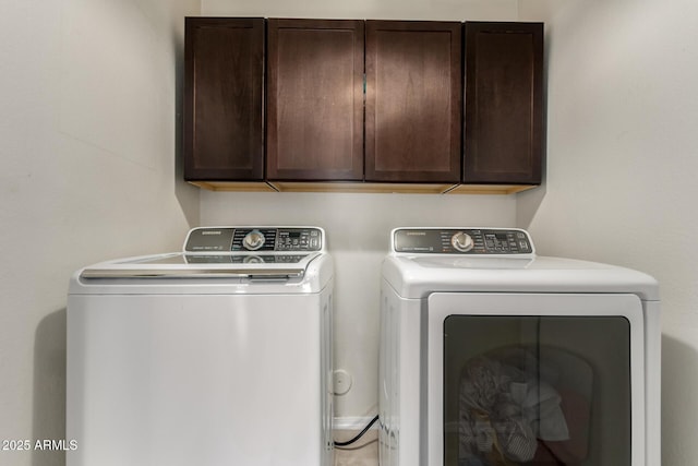 washroom with cabinet space and washing machine and dryer