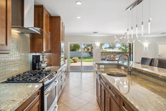 401 E Braeburn Dr, Phoenix, AZ 85022 - kitchen featuring stainless steel appliances, a sink, wall chimney exhaust hood, brown cabinetry, and decorative backsplash