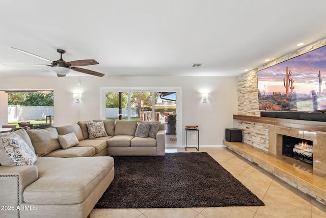 401 E Braeburn Dr, Phoenix, AZ 85022 - living room featuring healthy amount of natural light, ceiling fan, light tile patterned floors, and a fireplace