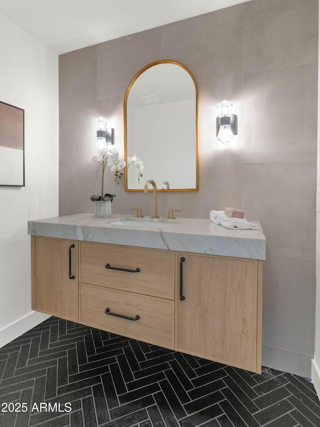 bathroom with baseboards and vanity