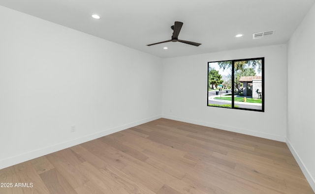 unfurnished room featuring light wood finished floors, recessed lighting, visible vents, ceiling fan, and baseboards