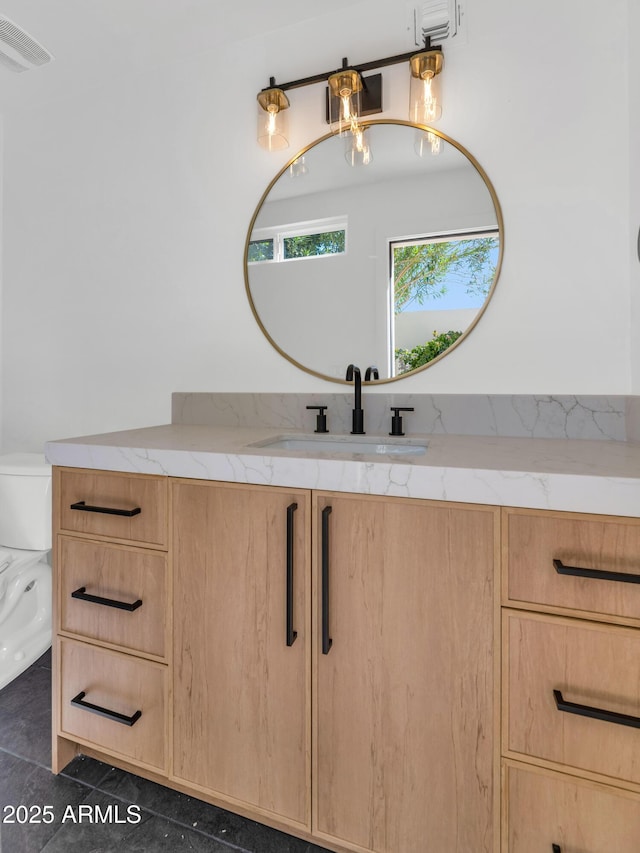 bathroom with toilet, tile patterned flooring, visible vents, and vanity