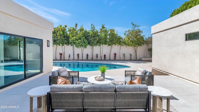 view of pool with a patio area, outdoor lounge area, a fenced backyard, and a fenced in pool