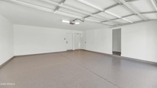 garage with a garage door opener and baseboards