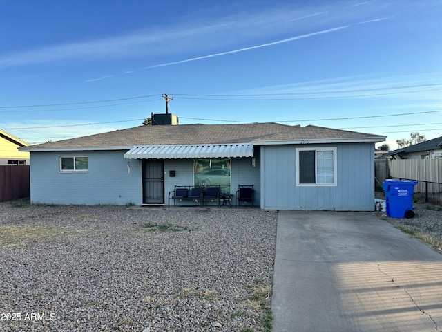 back of house with a patio, roof with shingles, and fence