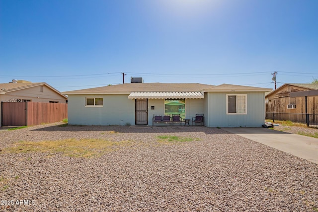 ranch-style house with fence and a patio