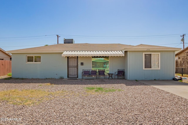 view of front of house featuring fence and a patio