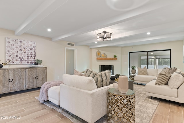 living area featuring wood tiled floor, visible vents, beamed ceiling, and recessed lighting