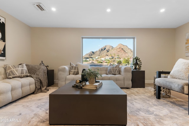 living room featuring recessed lighting, visible vents, a mountain view, and baseboards