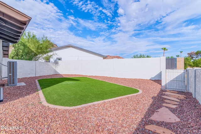 view of yard featuring a gate and a fenced backyard