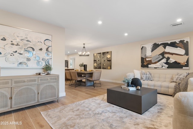 living room with recessed lighting, visible vents, wood tiled floor, a chandelier, and baseboards