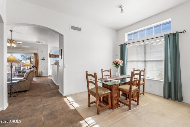 dining room with tile patterned flooring and ceiling fan