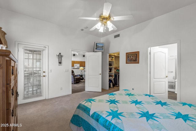 bedroom with ensuite bathroom, a walk in closet, light carpet, a closet, and ceiling fan