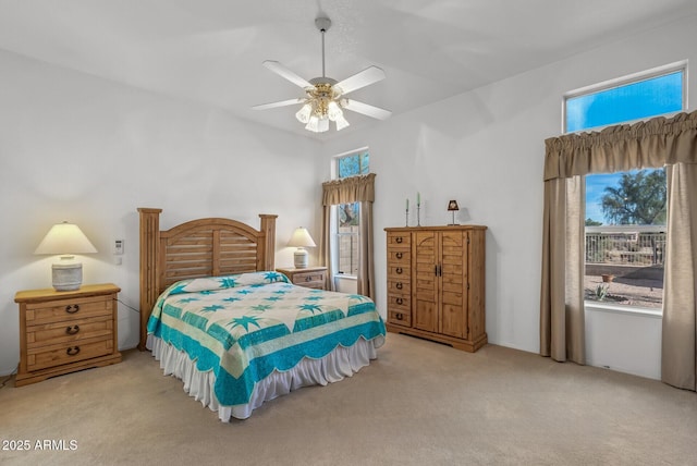 carpeted bedroom with ceiling fan and multiple windows