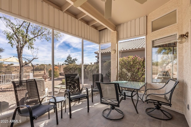 sunroom featuring ceiling fan