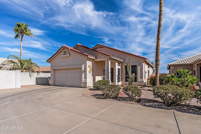 mediterranean / spanish-style home with a garage