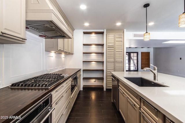 3646 W Brown St, Phoenix, AZ 85051 - kitchen with custom exhaust hood, a sink, appliances with stainless steel finishes, pendant lighting, and dark wood-style flooring