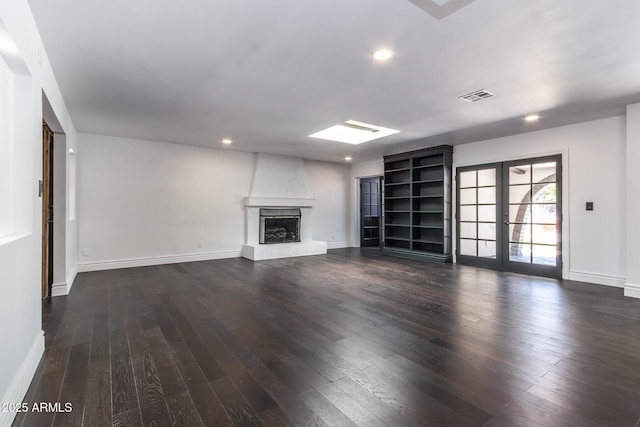 3646 W Brown St, Phoenix, AZ 85051 - unfurnished living room with a large fireplace, dark wood-style flooring, baseboards, recessed lighting, and french doors
