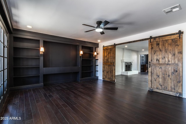 3646 W Brown St, Phoenix, AZ 85051 - unfurnished living room with a barn door, ceiling fan, baseboards, wood finished floors, and recessed lighting