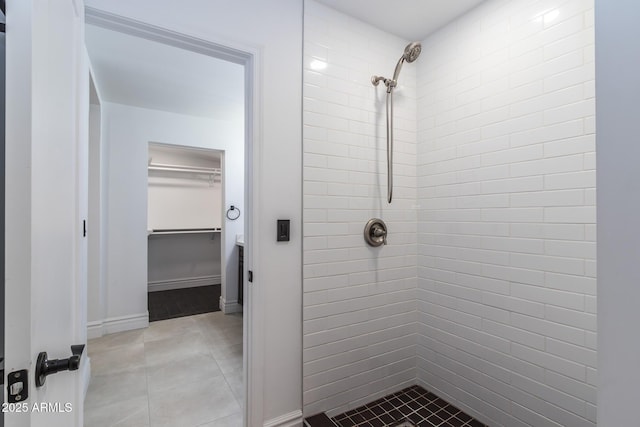 3646 W Brown St, Phoenix, AZ 85051 - full bathroom with a tile shower, a walk in closet, tile patterned flooring, and baseboards