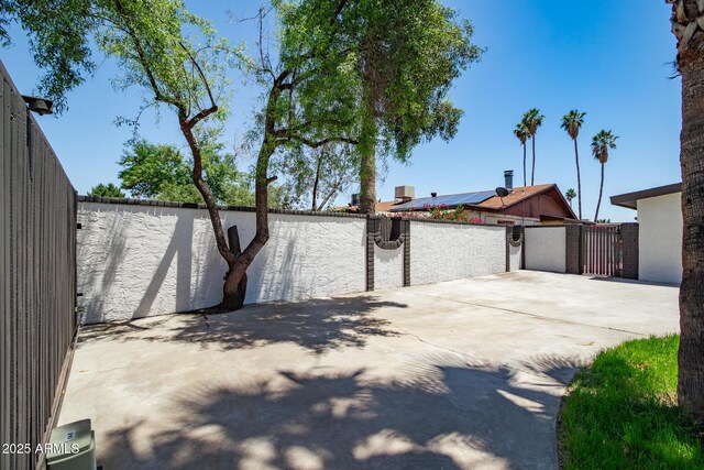 3646 W Brown St, Phoenix, AZ 85051 - garage with roof mounted solar panels and a gate