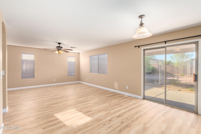 spare room with ceiling fan and light hardwood / wood-style flooring