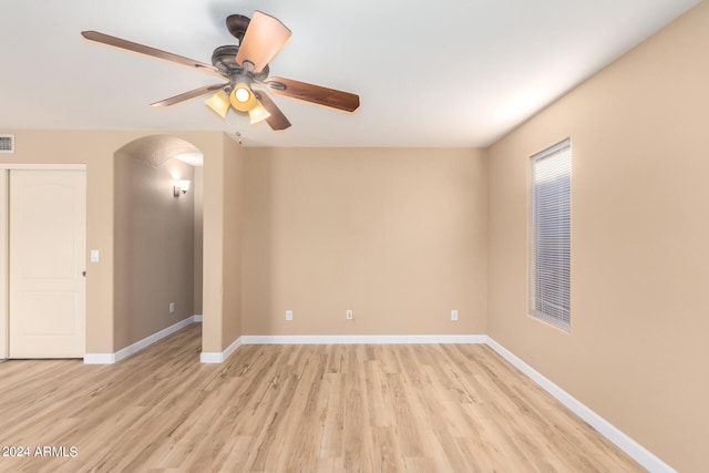 empty room with ceiling fan and light hardwood / wood-style flooring