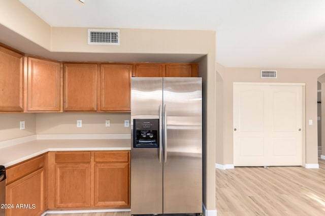 kitchen featuring light wood-type flooring and stainless steel refrigerator with ice dispenser