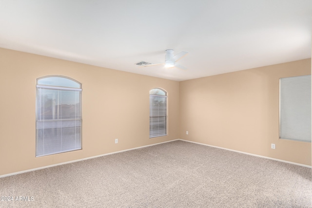 carpeted empty room featuring ceiling fan