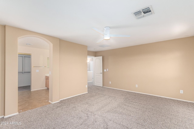 unfurnished room featuring light carpet and ceiling fan