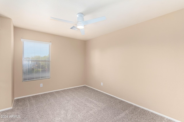 spare room with carpet floors and ceiling fan