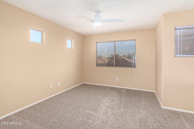 carpeted empty room featuring ceiling fan