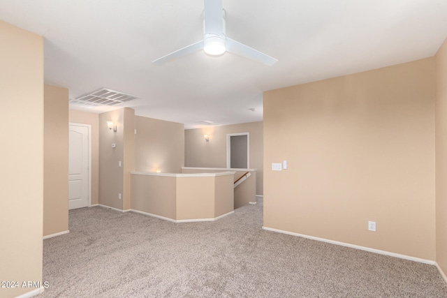 unfurnished room with light carpet and ceiling fan