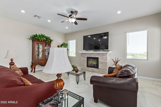 living room with plenty of natural light, a fireplace, and light tile floors